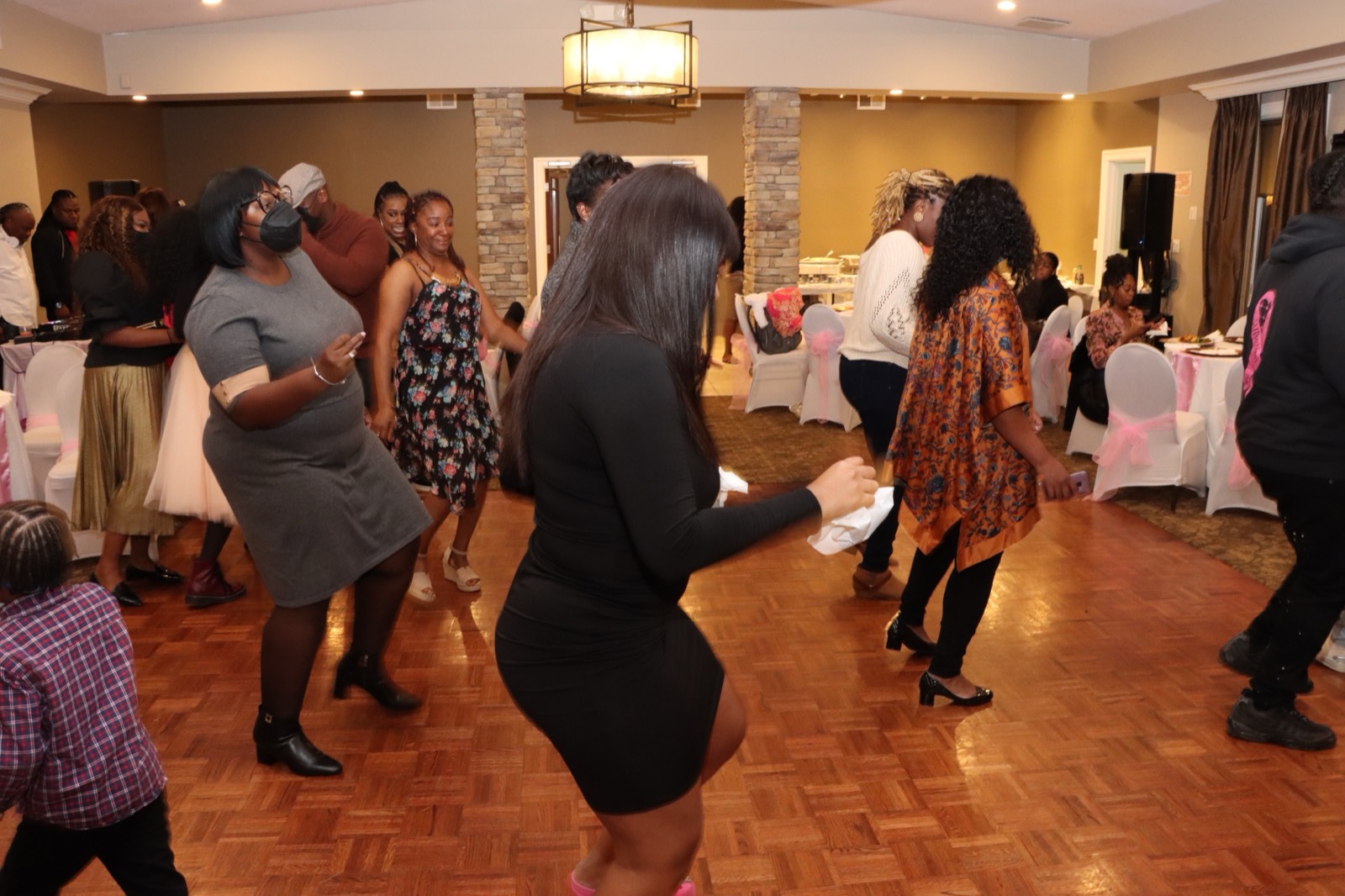Guests line dancing together at the first-birthday celebration.